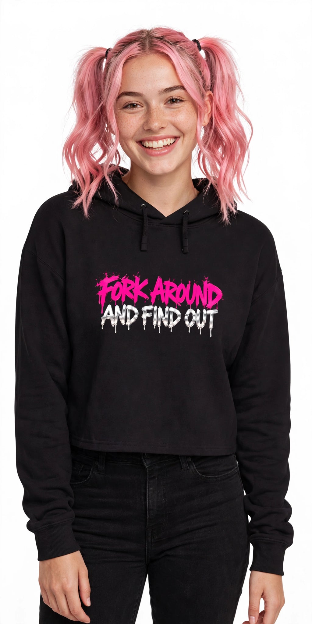 Woman with pink hair in pigtails wearing the Fork Around And Find Out crop hoodie with black jeans