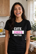 Woman wearing the Cute Chefs Matter fitted tee in her kitchen